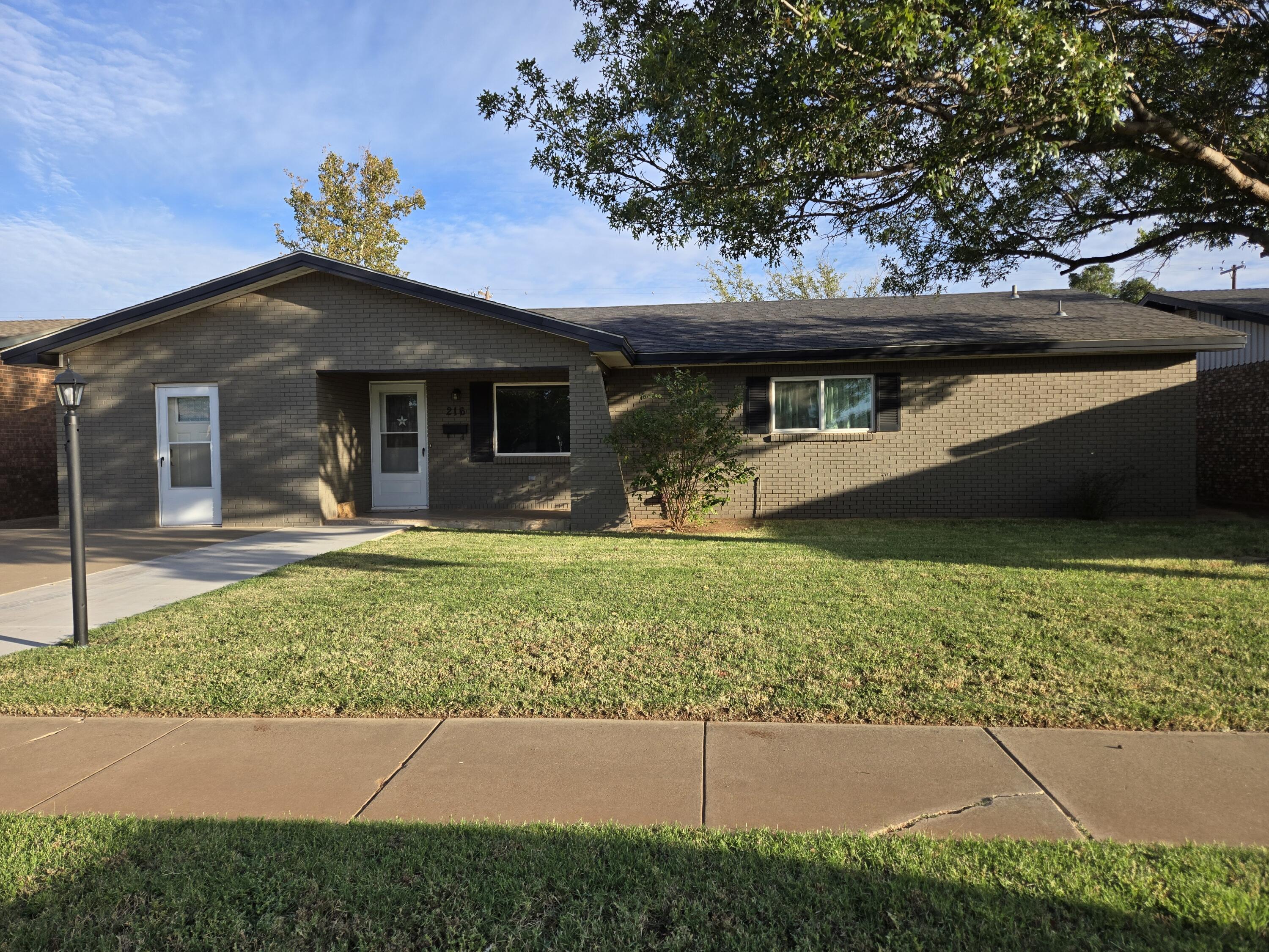 216 North 24th Street Lamesa, TX 79331 - Photo 23 of 27 a front view of a house with a garden