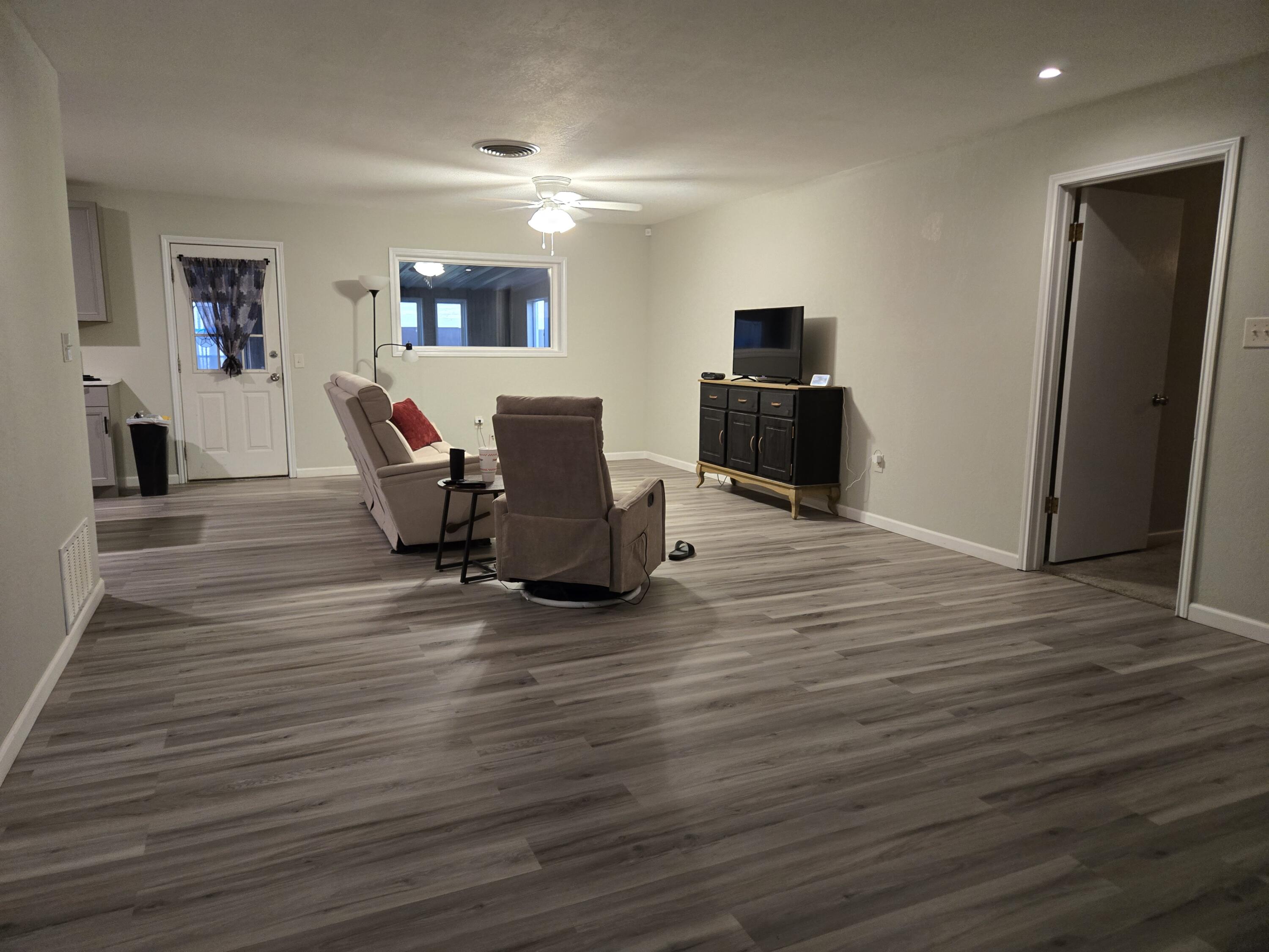 216 North 24th Street Lamesa, TX 79331 - Photo 3 of 27 a living room with furniture and a wooden floor
