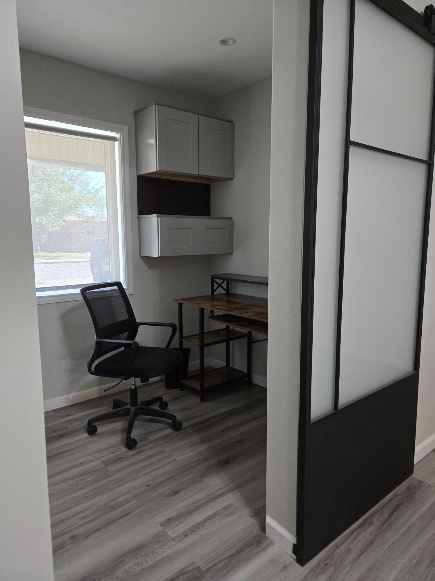 216 North 24th Street Lamesa, TX 79331 - Photo 4 of 27 a view of a workspace with furniture and a window