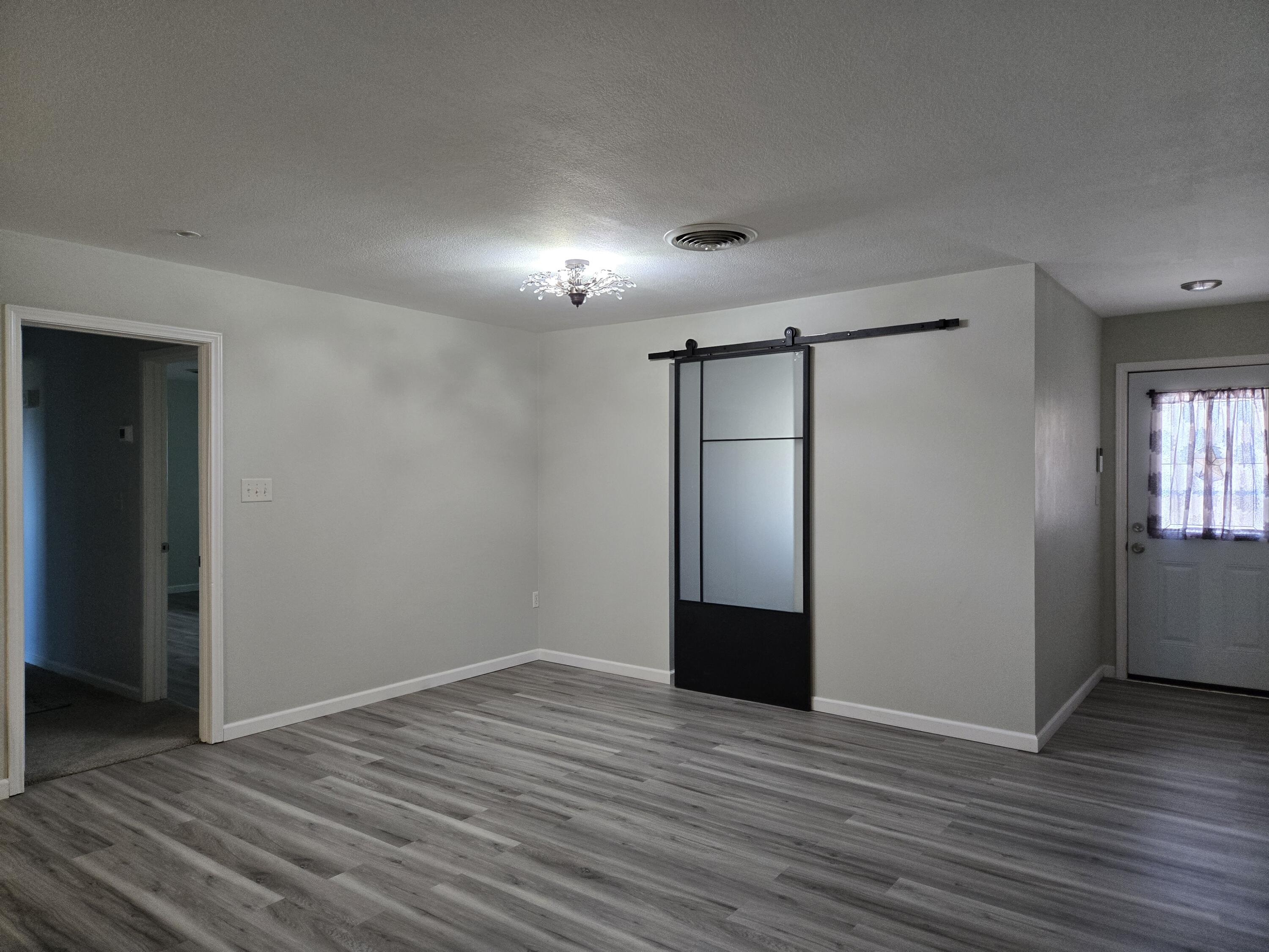 216 North 24th Street Lamesa, TX 79331 - Photo 6 of 27 a view of empty room with wooden floor