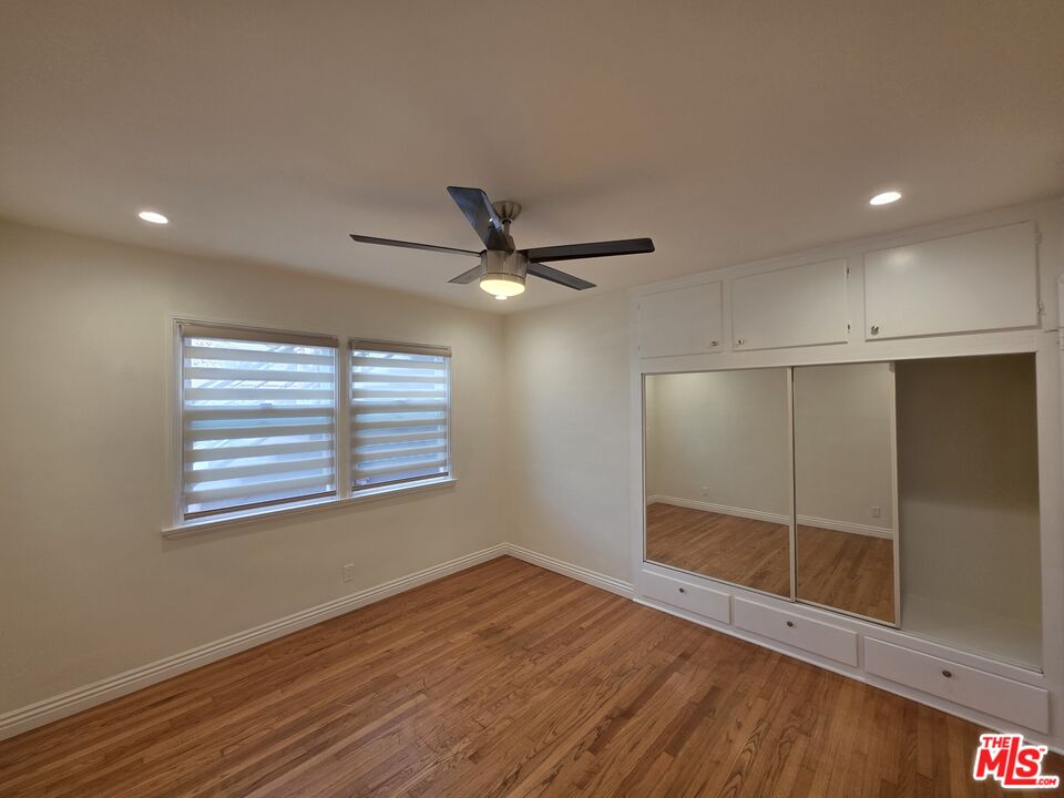 102 Gaviota Avenue, Unit 104 Long Beach, CA 90802 - Photo 11 of 42 a view of an empty room with wooden floor and a window