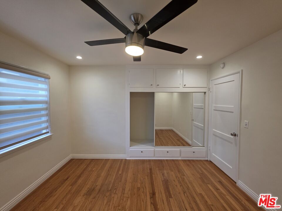 102 Gaviota Avenue, Unit 104 Long Beach, CA 90802 - Photo 12 of 42 an empty room with wooden floor fan and windows