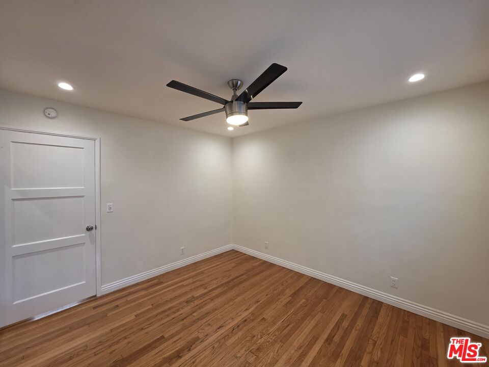 102 Gaviota Avenue, Unit 104 Long Beach, CA 90802 - Photo 15 of 42 a view of a room with wooden floor and a ceiling fan