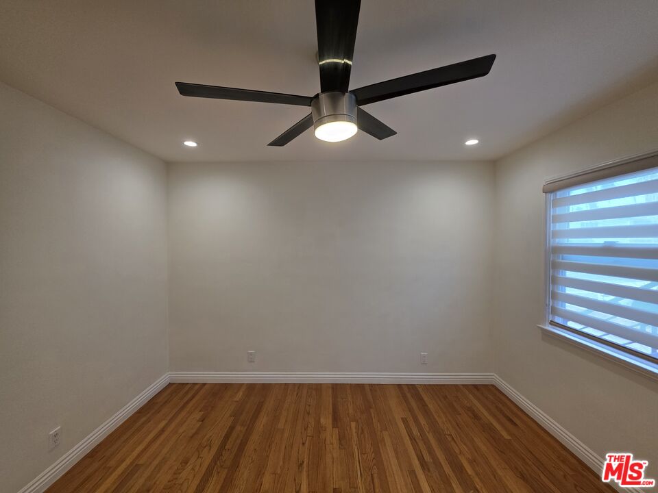 102 Gaviota Avenue, Unit 104 Long Beach, CA 90802 - Photo 16 of 42 a view of an empty room with wooden floor and a window