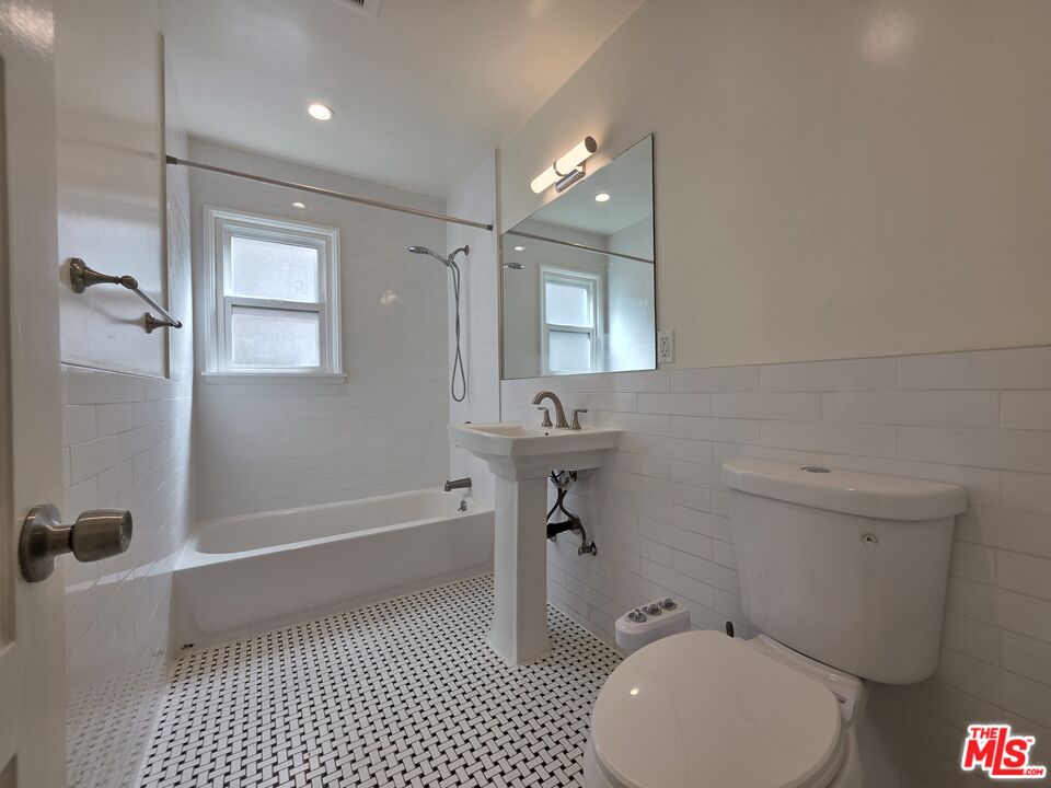 102 Gaviota Avenue, Unit 104 Long Beach, CA 90802 - Photo 19 of 42 a bathroom with a sink a toilet and shower