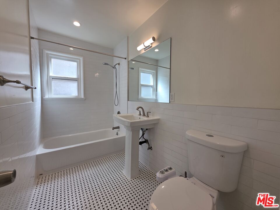 102 Gaviota Avenue, Unit 104 Long Beach, CA 90802 - Photo 20 of 42 a bathroom with a sink a toilet a mirror and bathtub