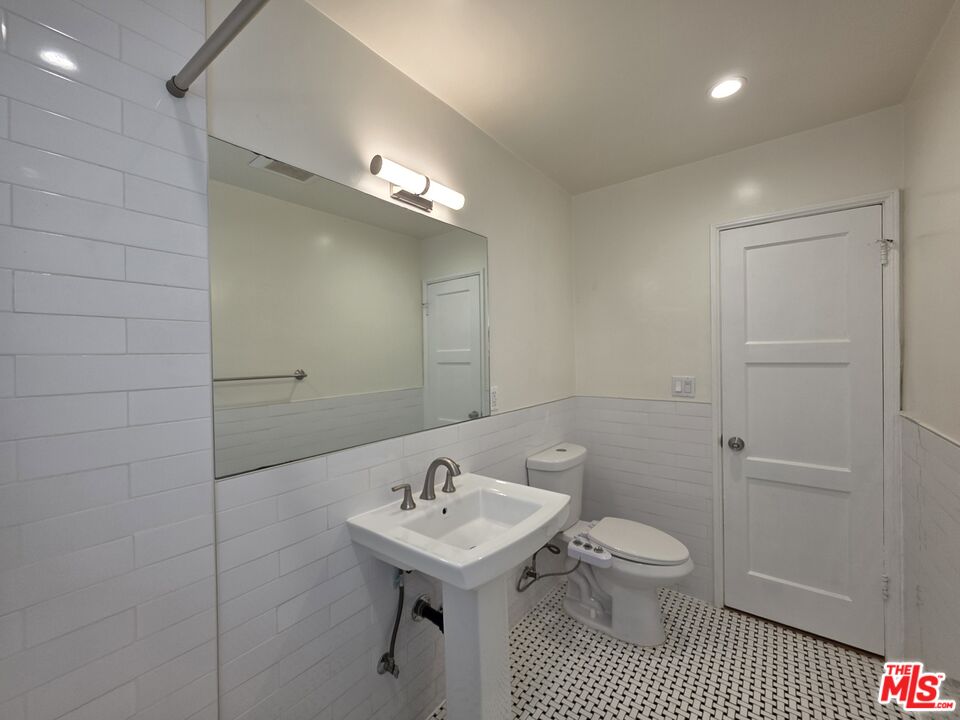 102 Gaviota Avenue, Unit 104 Long Beach, CA 90802 - Photo 22 of 42 a bathroom with a sink a toilet and shower