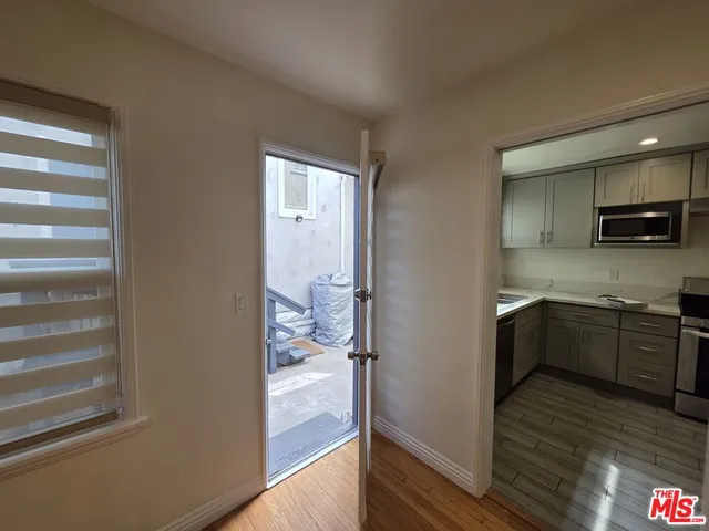 a kitchen with a refrigerator and a stove top oven