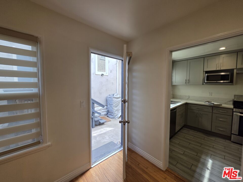 102 Gaviota Avenue, Unit 104 Long Beach, CA 90802 - Photo 26 of 42 a kitchen with a refrigerator and a stove top oven