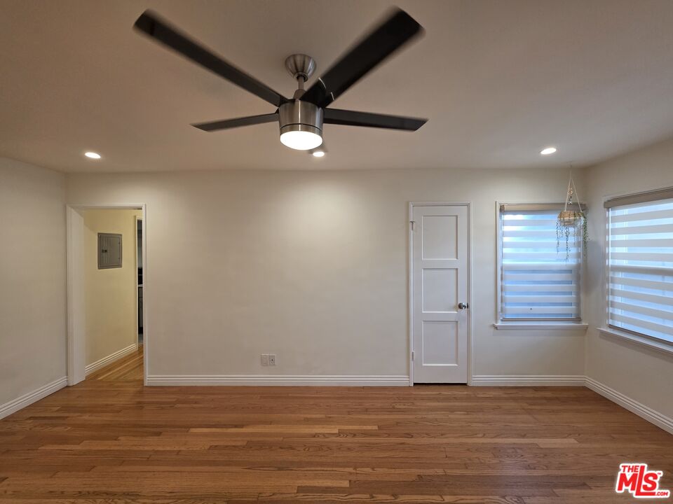 102 Gaviota Avenue, Unit 104 Long Beach, CA 90802 - Photo 29 of 42 an empty room with wooden floor fan and windows