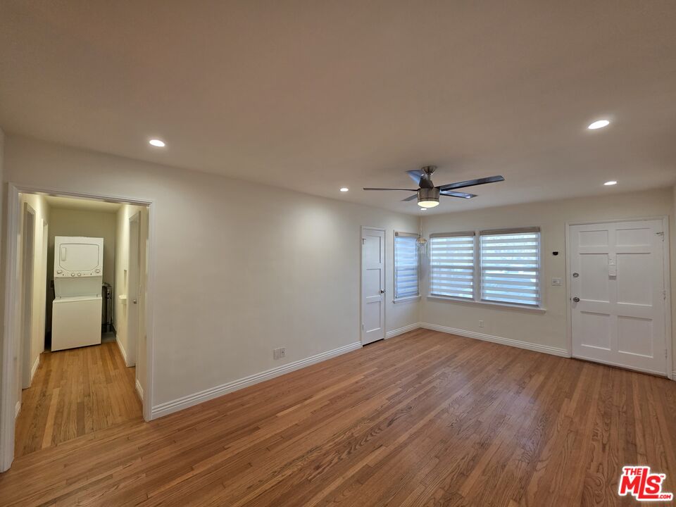 102 Gaviota Avenue, Unit 104 Long Beach, CA 90802 - Photo 30 of 42 an empty room with wooden floor and windows