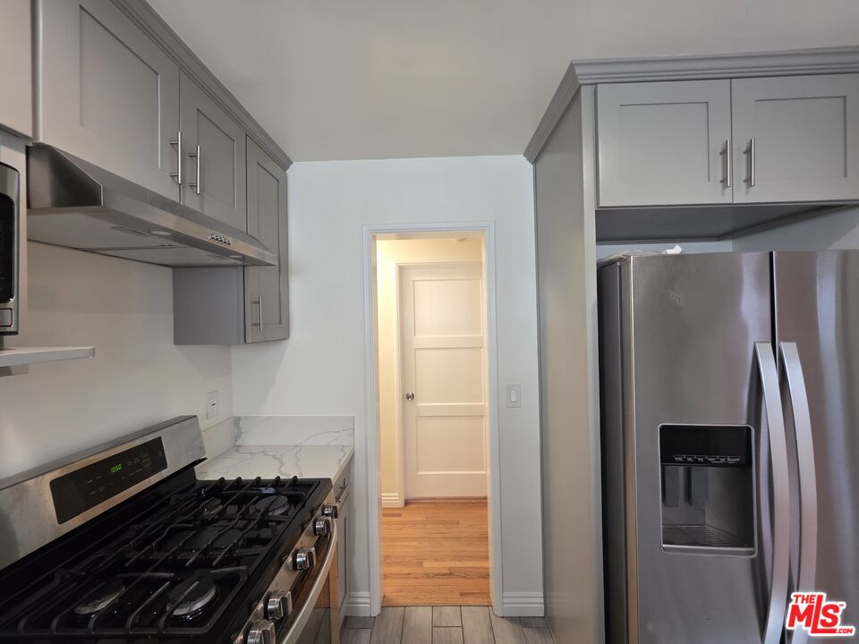 102 Gaviota Avenue, Unit 104 Long Beach, CA 90802 - Photo 3 of 42 a kitchen with stainless steel appliances granite countertop a refrigerator and a stove top oven