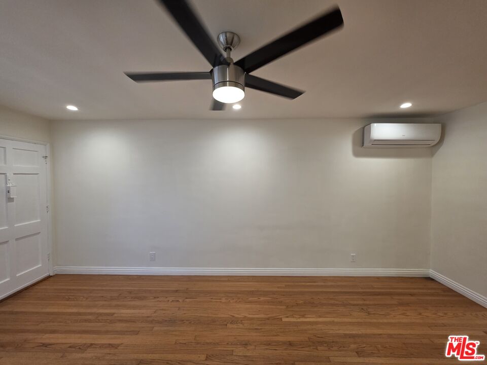 102 Gaviota Avenue, Unit 104 Long Beach, CA 90802 - Photo 33 of 42 an empty room with wooden floor and windows