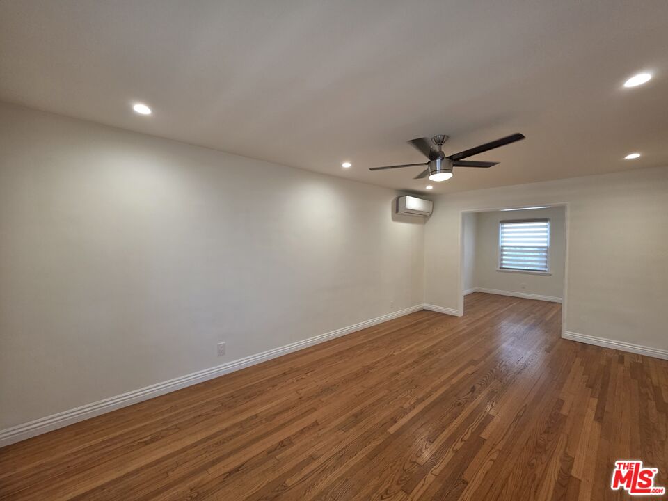 102 Gaviota Avenue, Unit 104 Long Beach, CA 90802 - Photo 34 of 42 an empty room with wooden floor and windows