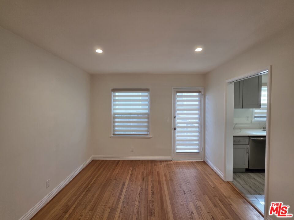 102 Gaviota Avenue, Unit 104 Long Beach, CA 90802 - Photo 35 of 42 an empty room with wooden floor and a window