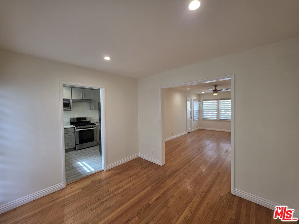 102 Gaviota Avenue, Unit 104 Long Beach, CA 90802 - Photo 38 of 42 a view of a kitchen and an empty room with wooden floor and a kitchen