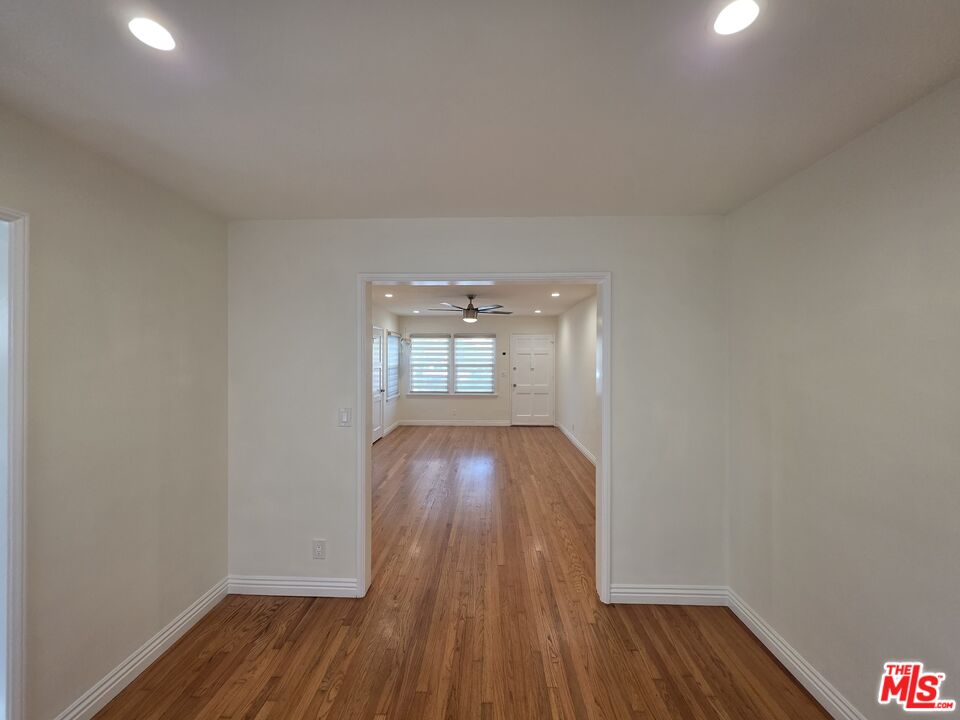 102 Gaviota Avenue, Unit 104 Long Beach, CA 90802 - Photo 39 of 42 an empty room with wooden floor and windows