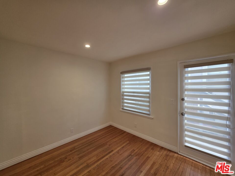 102 Gaviota Avenue, Unit 104 Long Beach, CA 90802 - Photo 42 of 42 a view of an empty room with wooden floor and a window