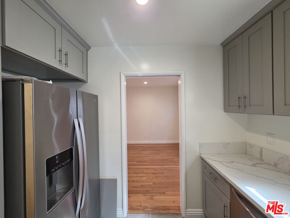 102 Gaviota Avenue, Unit 104 Long Beach, CA 90802 - Photo 6 of 42 a kitchen with stainless steel appliances granite countertop a refrigerator and a sink
