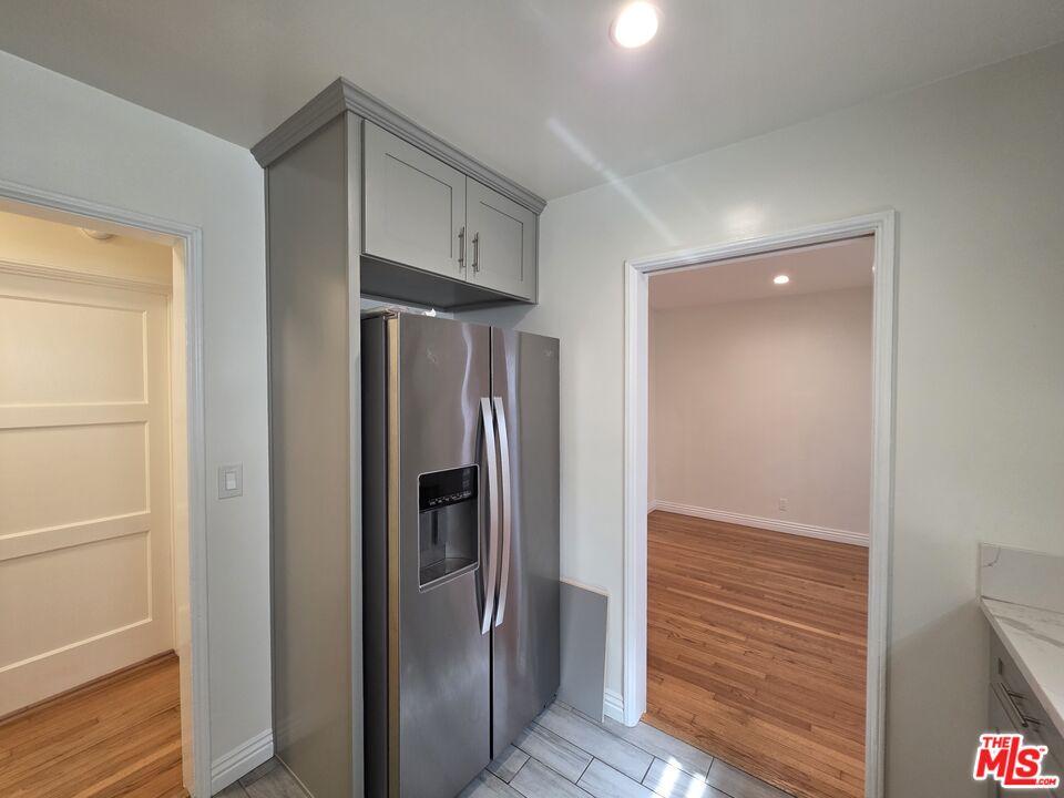 102 Gaviota Avenue, Unit 104 Long Beach, CA 90802 - Photo 7 of 42 a view of hallway with stainless steel appliances wooden floor and staircase
