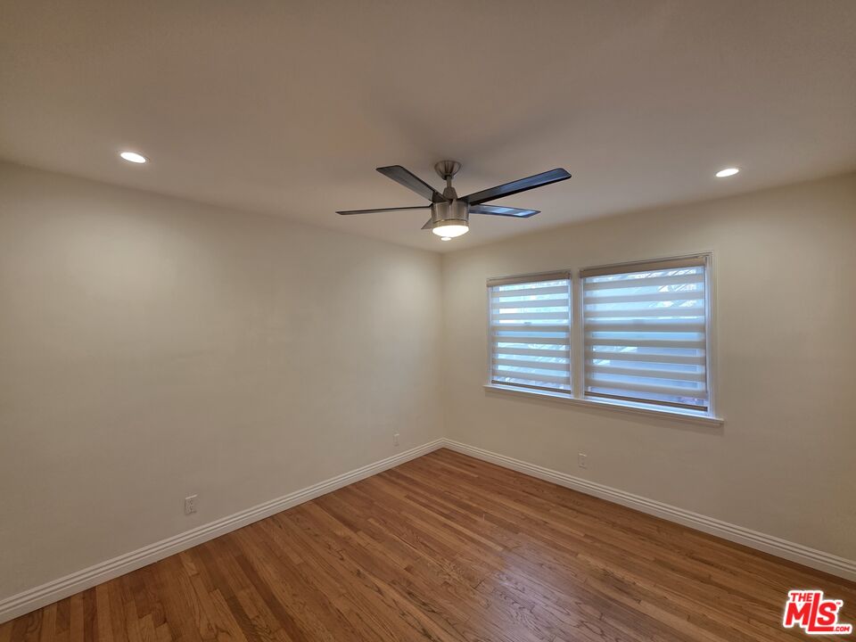 102 Gaviota Avenue, Unit 104 Long Beach, CA 90802 - Photo 9 of 42 a view of an empty room with wooden floor and a window