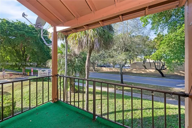 a view of a yard with a large tree