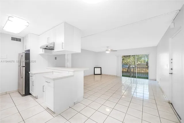 a kitchen with a stove a refrigerator and cabinets