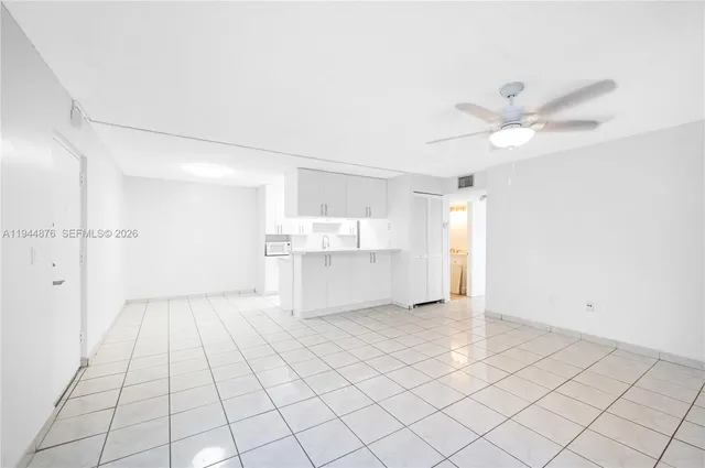 a view of a kitchen with wooden cabinet and a chandelier fan