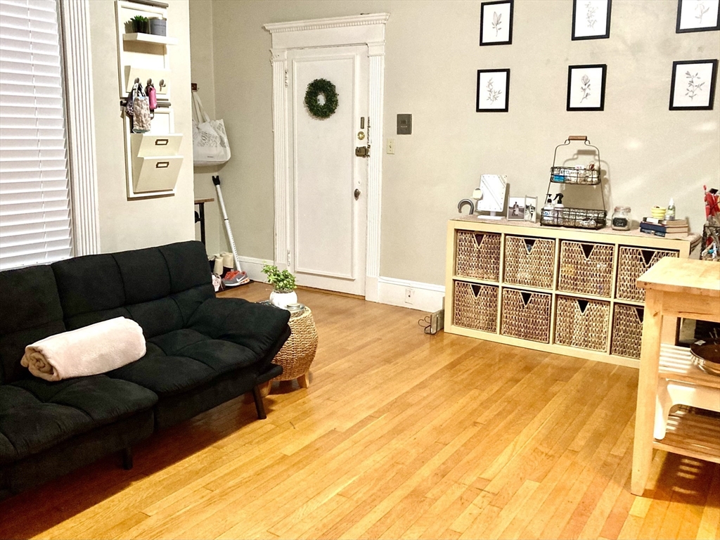 8 Garrison Street, Unit 608 Boston, MA 02116 - Photo 2 of 13 a living room with furniture and a large window