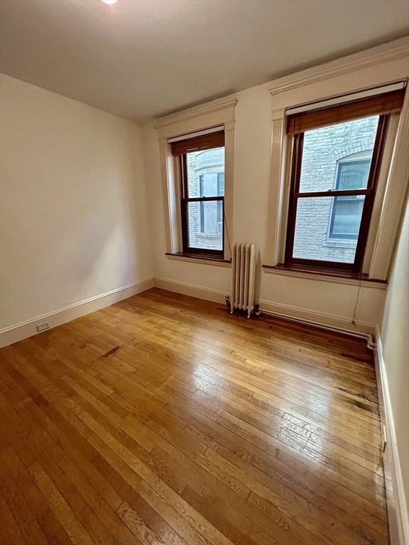 8 Garrison Street, Unit 608 Boston, MA 02116 - Photo 3 of 13 a view of an empty room with wooden floor and a window