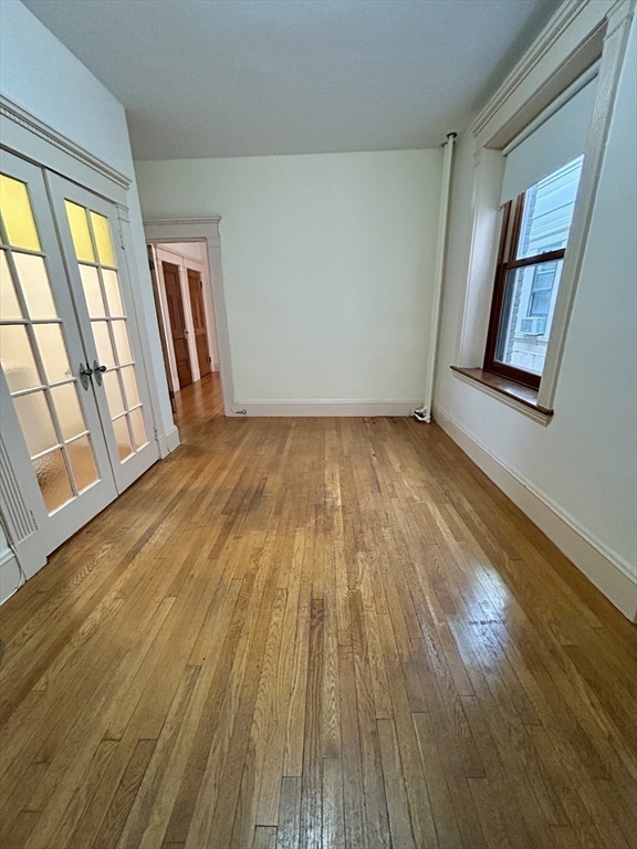 8 Garrison Street, Unit 608 Boston, MA 02116 - Photo 4 of 13 a view of an empty room and wooden floor and windows
