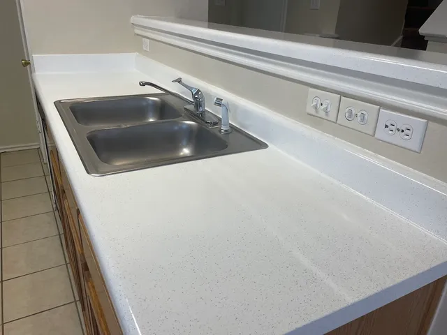 an empty room with a chandelier fan and a chandelier fan