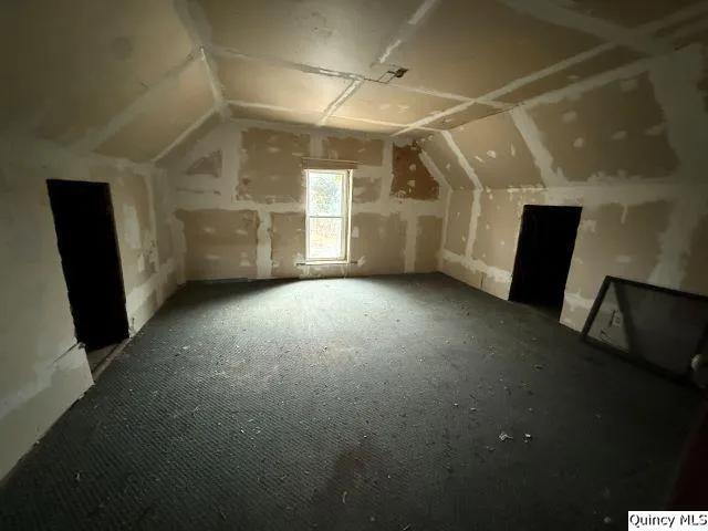 a view of a livingroom with an empty space and a window