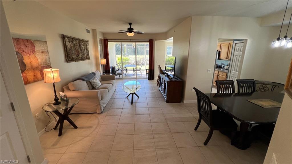 5705 Mayflower Way, Unit 1402 Ave Maria, FL 34142 - Photo 12 of 35 a living room with furniture a rug and a chandelier