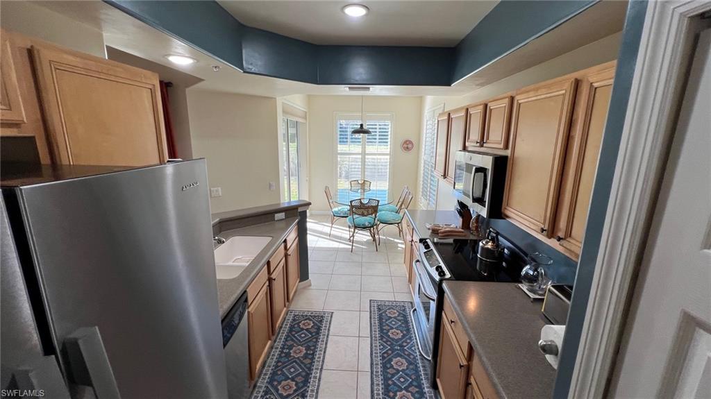 5705 Mayflower Way, Unit 1402 Ave Maria, FL 34142 - Photo 14 of 35 a view of a hallway with furniture and floor to ceiling window
