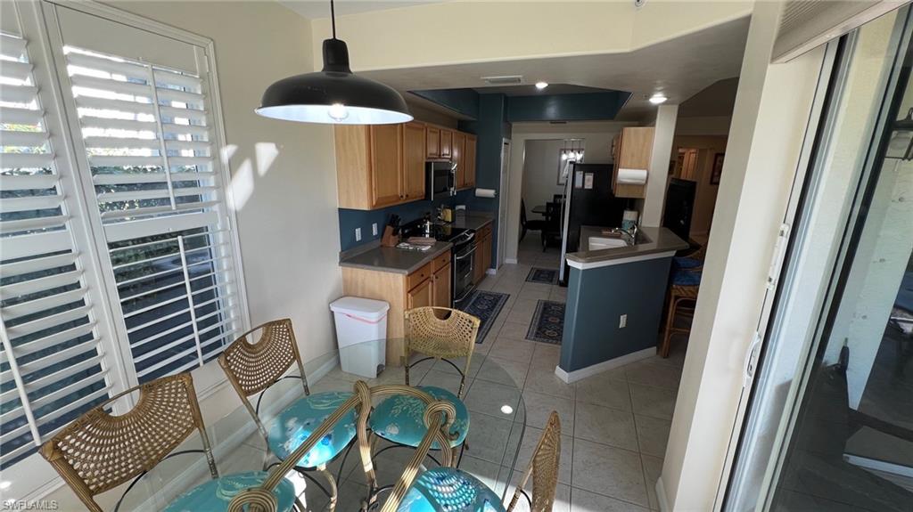 5705 Mayflower Way, Unit 1402 Ave Maria, FL 34142 - Photo 15 of 35 a living room with furniture and a window