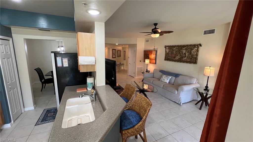 5705 Mayflower Way, Unit 1402 Ave Maria, FL 34142 - Photo 16 of 35 a living room with furniture and a chandelier