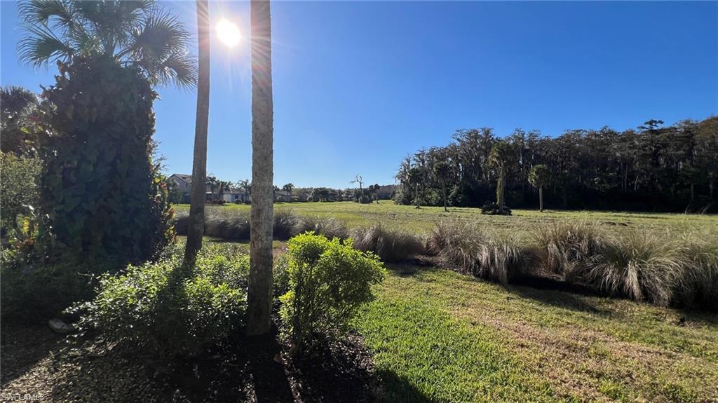 5705 Mayflower Way, Unit 1402 Ave Maria, FL 34142 - Photo 20 of 35 a view of a garden with a bench