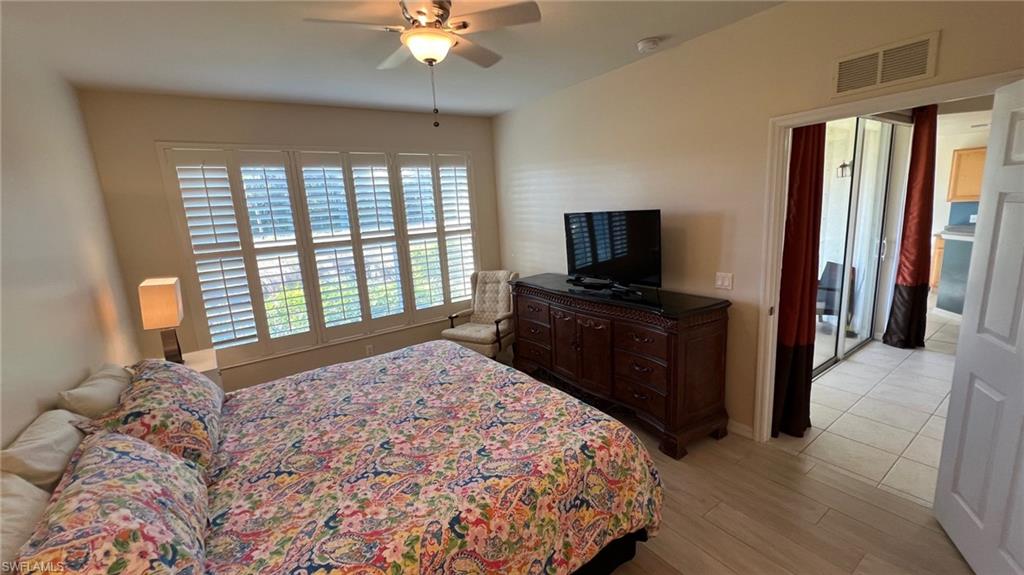 5705 Mayflower Way, Unit 1402 Ave Maria, FL 34142 - Photo 21 of 35 a bedroom with a bed and a flat screen tv