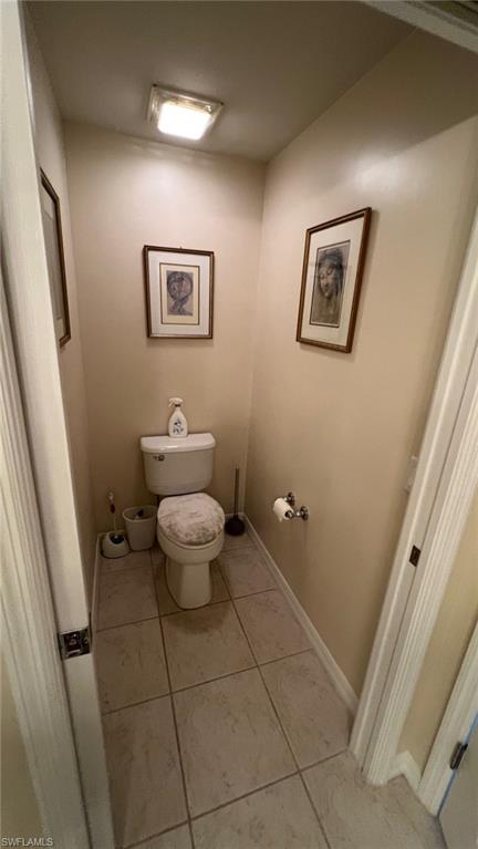 5705 Mayflower Way, Unit 1402 Ave Maria, FL 34142 - Photo 25 of 35 a bathroom with a toilet and a mirror