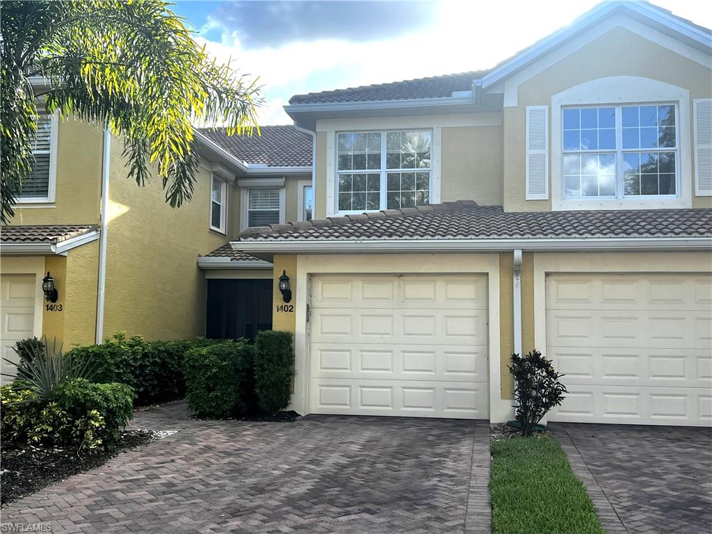 5705 Mayflower Way, Unit 1402 Ave Maria, FL 34142 - Photo 3 of 35 a front view of a house with a garden