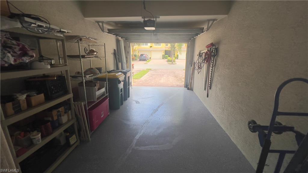 5705 Mayflower Way, Unit 1402 Ave Maria, FL 34142 - Photo 31 of 35 a hallway with a washer and dryer