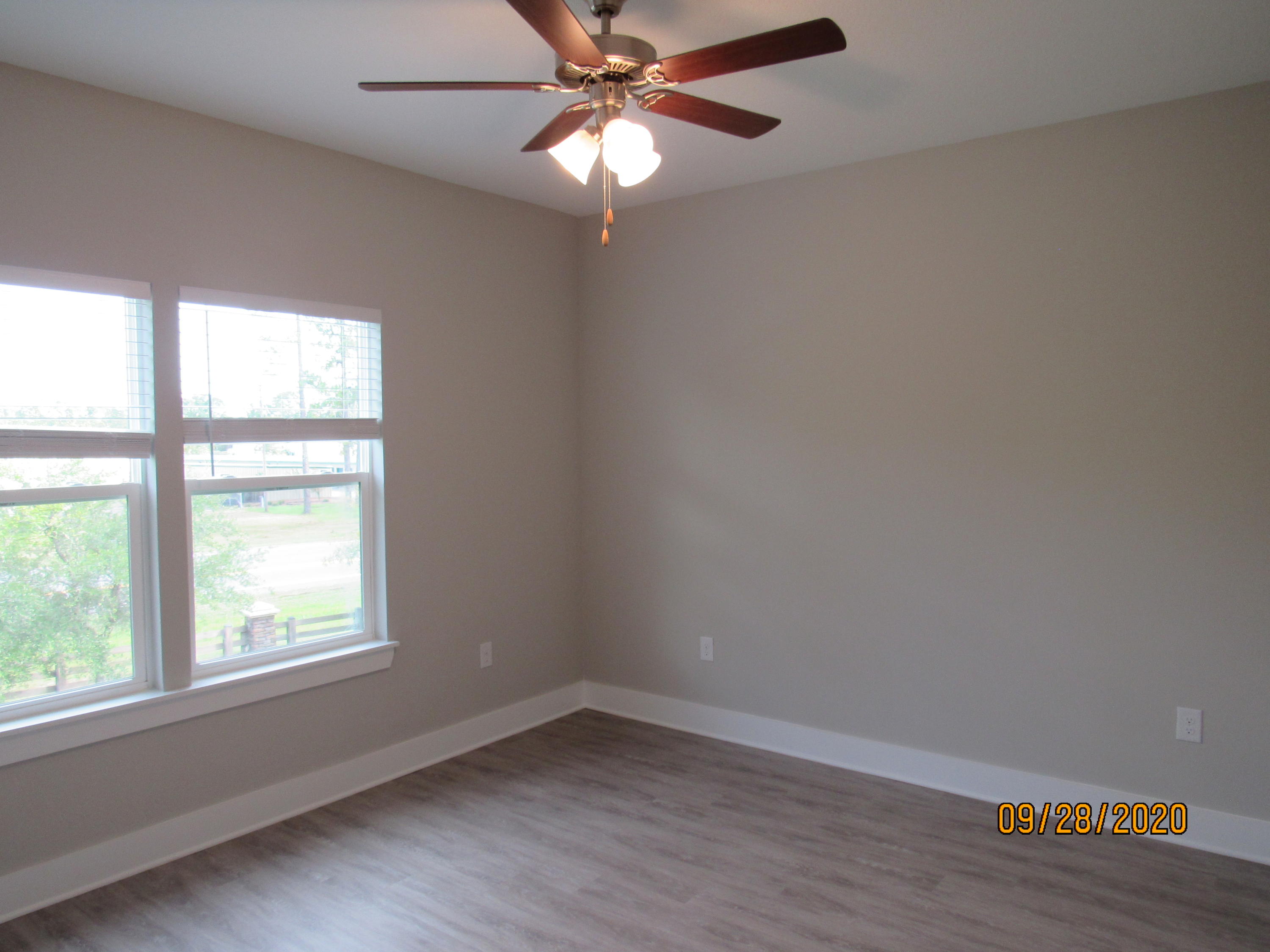 47 South Sand Palm Road Freeport, FL 32439 - Photo 7 of 12 an empty room with a window and a fan