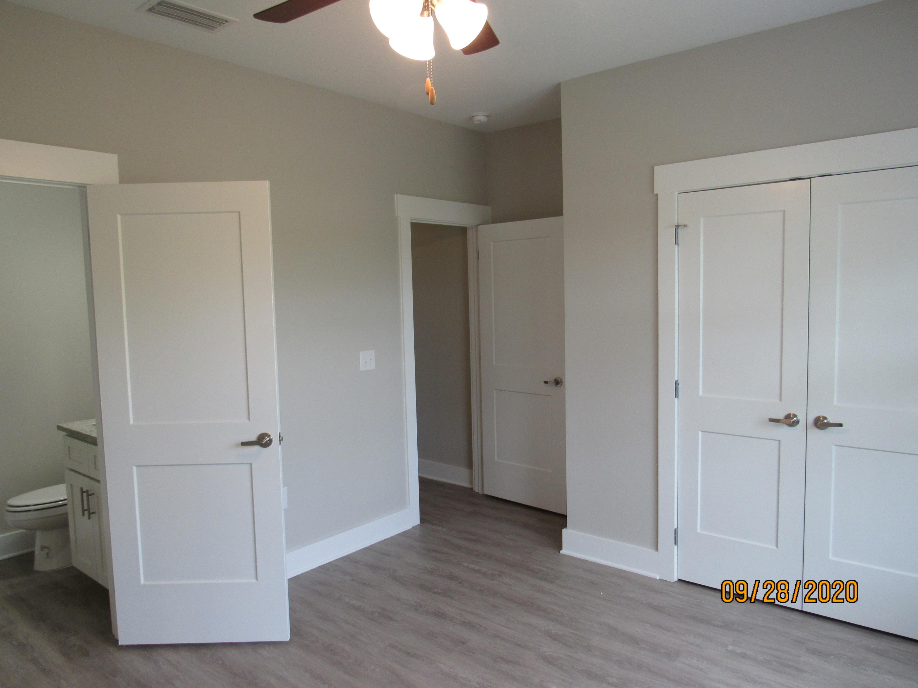 47 South Sand Palm Road Freeport, FL 32439 - Photo 8 of 12 an empty room with wooden floor and a ceiling fan