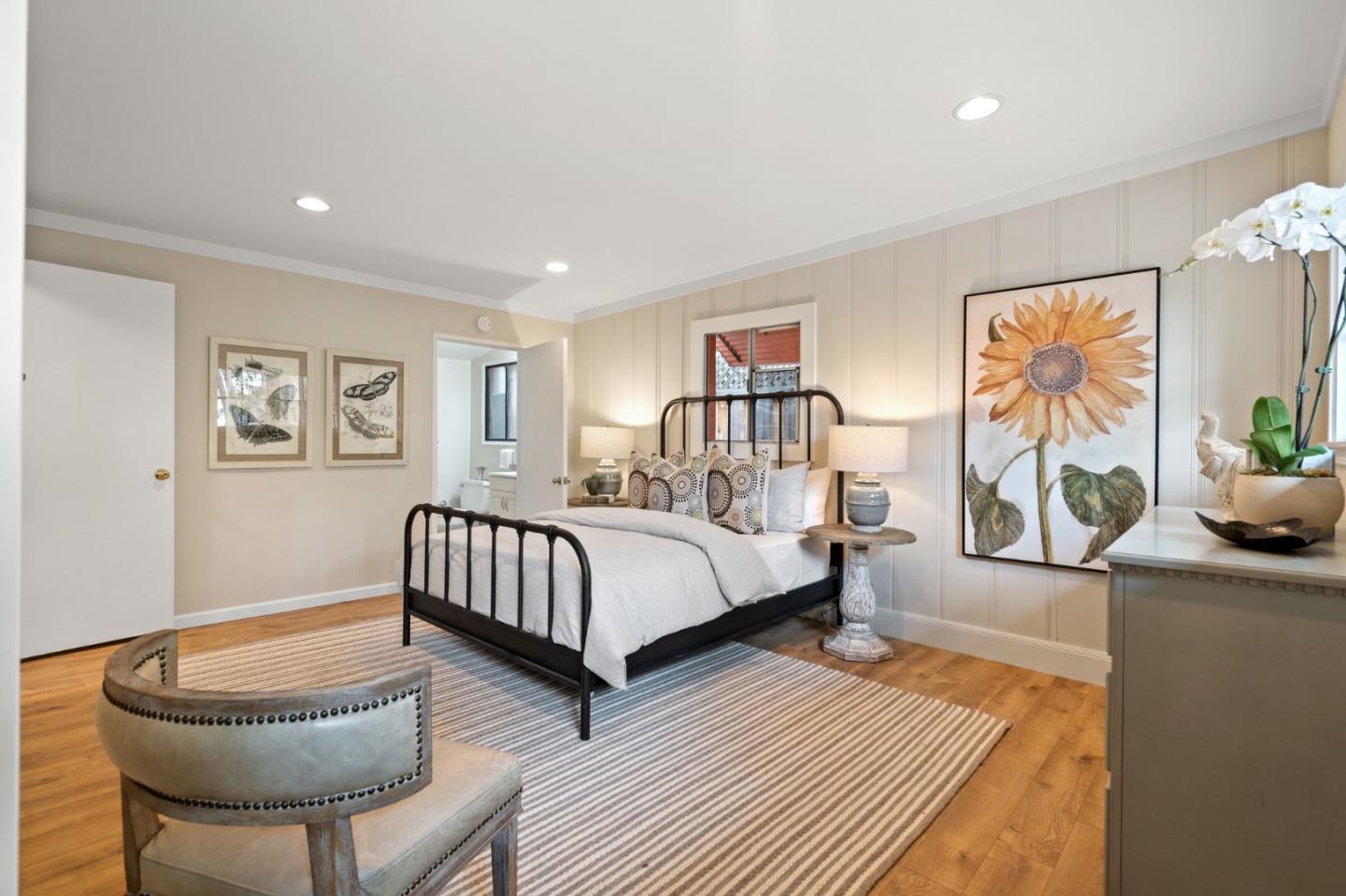 139 Warren Road San Mateo, CA 94401 - Photo 44 of 63 a spacious bedroom with a bed and a couch