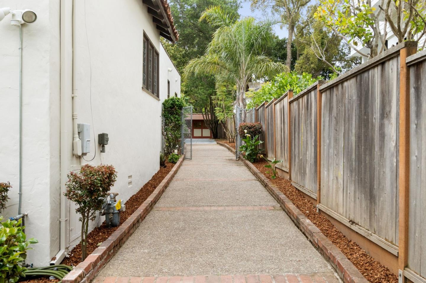 139 Warren Road San Mateo, CA 94401 - Photo 49 of 63 a view of a pathway of a house with backyard and trees