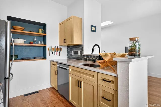 a kitchen with a sink cabinets and appliances