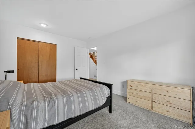 a bedroom with a bed and a night stand