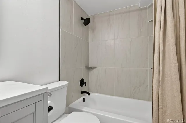 a view of a patio with table and chairs with wooden floor and fence