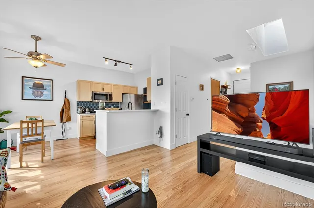 a living room with furniture and kitchen view